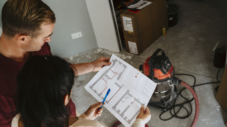A couple looking at a home floor plan