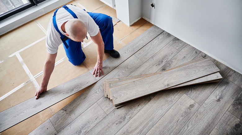 A person installing a new floor