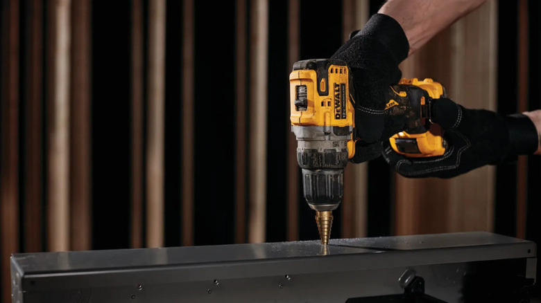 A person drilling with DeWalt's 12V Max Xtreme Brushless ⅜-inch Drill Driver