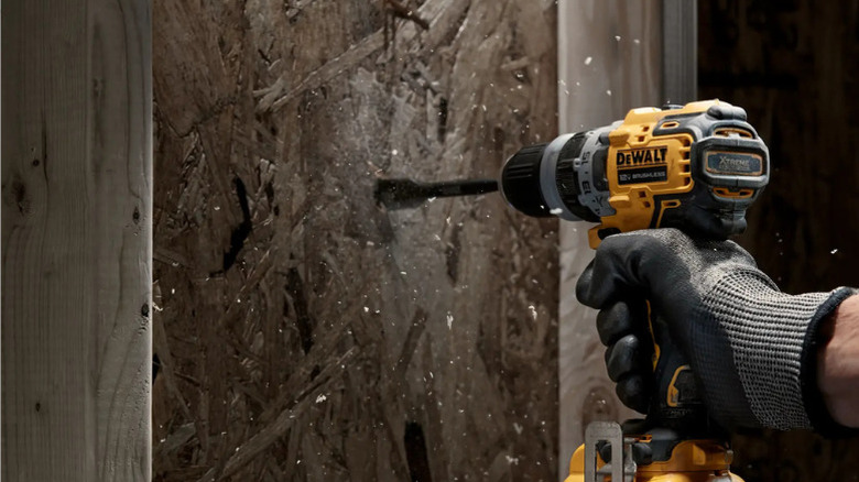 Close-up of a person drilling a wall with DeWalt's Xtreme 12V Max Brushless Drill Driver