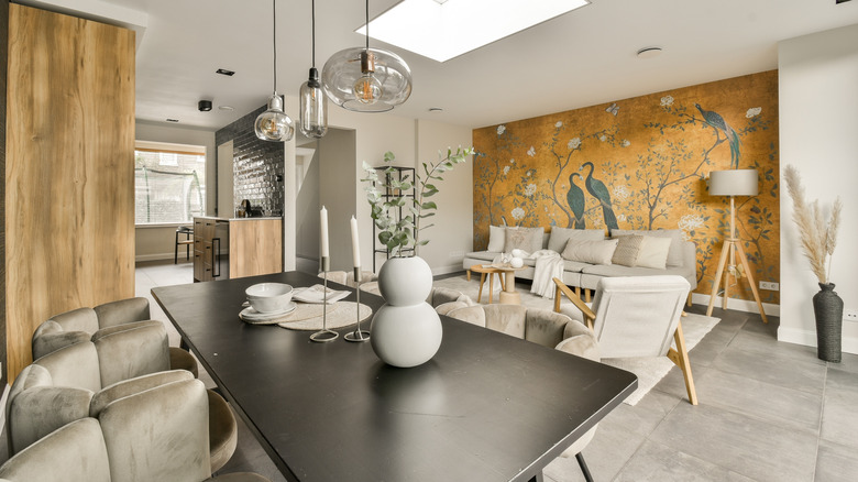 An open concept living and dining room with a chinoiserie accent wall.