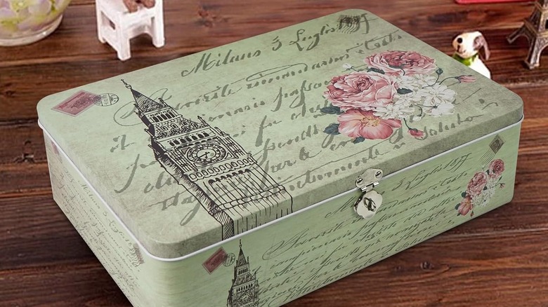 A decorative metal tin with latch