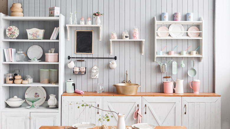 A kitchen wall with open shelving cabinets