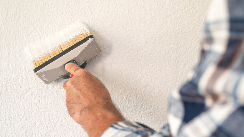 Close-up of a painter working with a masonry brush