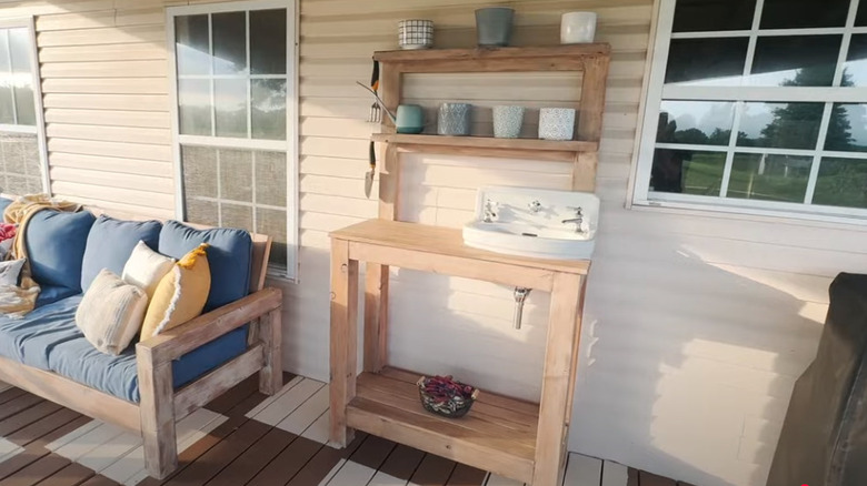 Wooden handmade potting bench with old bathroom sink