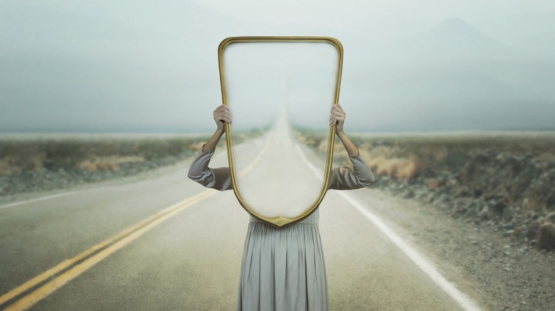 woman holding mirror