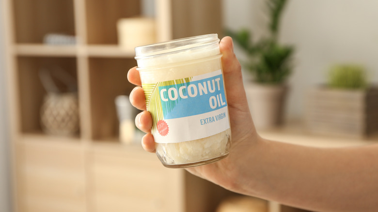 person holding coconut oil