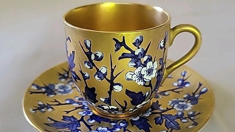 Coalport Demitasse cup and saucer with gold and blue flower design