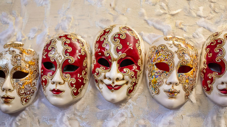 Elegant gold, red, and white venetian masks.