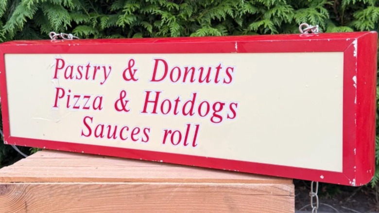 A vintage red and white food neon sign.