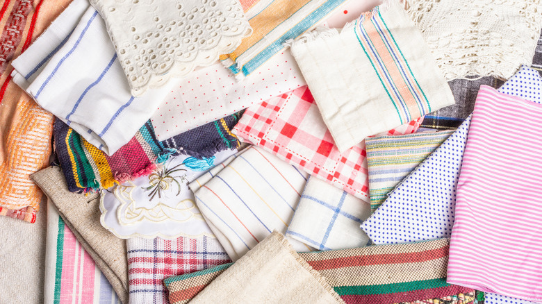 A pile of vintage linens in all sorts of patterns, colors, and materials