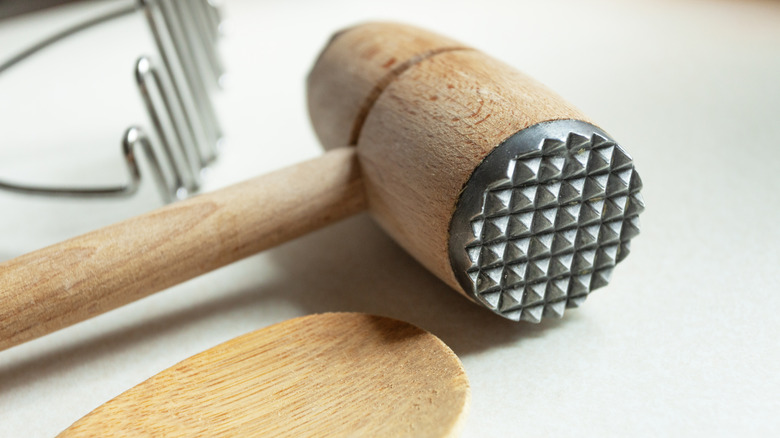 A close up of the textured side of a meat tenderizer.