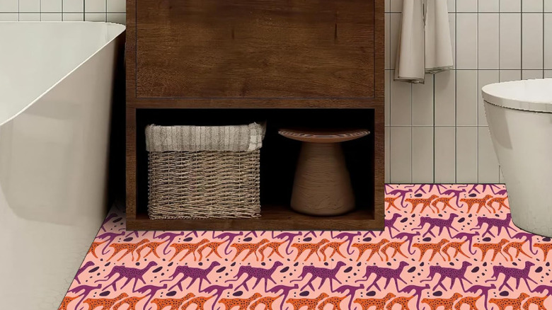 A bathroom with pink, purple and orange cheetah design.
