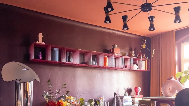 Room with plum walls and peach ceiling.