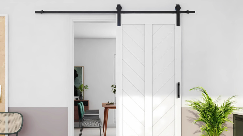 A sliding barn door in a living room.