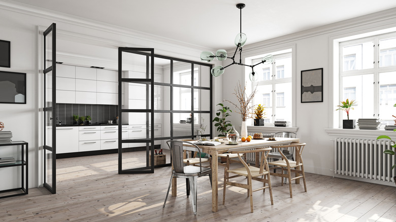 A kitchen with a glass partition wall.