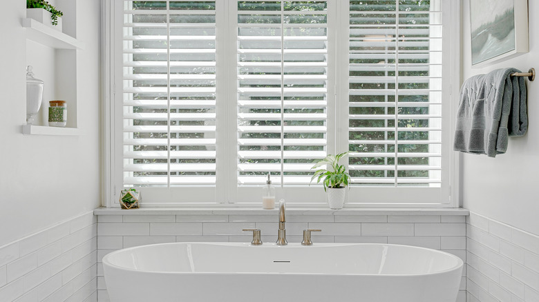 A bathroom with plantation shutters.