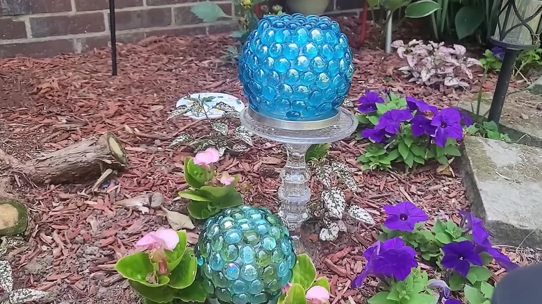 Gemstone-covered orbs made from round vases with solar lights to make them glow at night