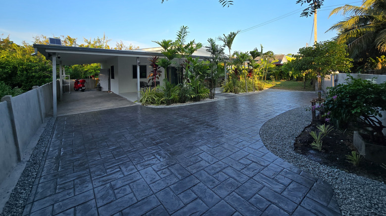 A stamped concrete driveway that looks like cobblestones.