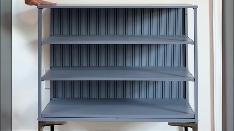 Cabinet repurposed with pole wrap for standing shelves