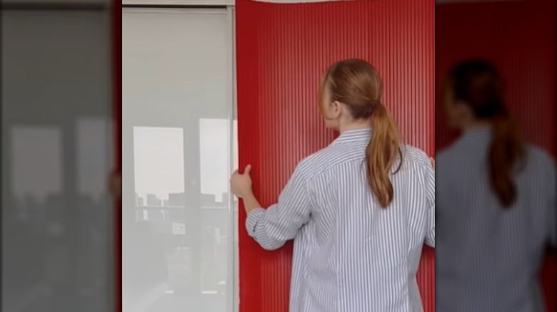 Person putting pole wrap over closet door