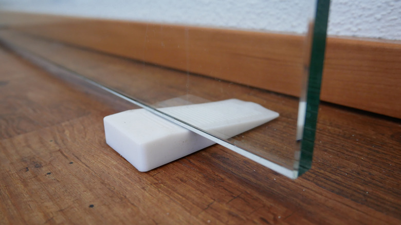 marble door stop wedge under glass door