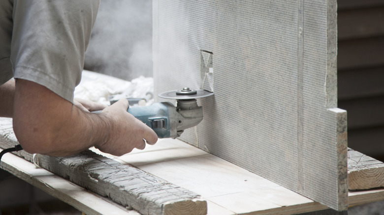 Man cutting granite counter top