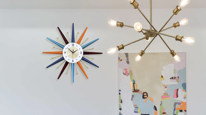 Fieldy's atomic-inspired wall clock next to a sputnik chandelier and a colorful print