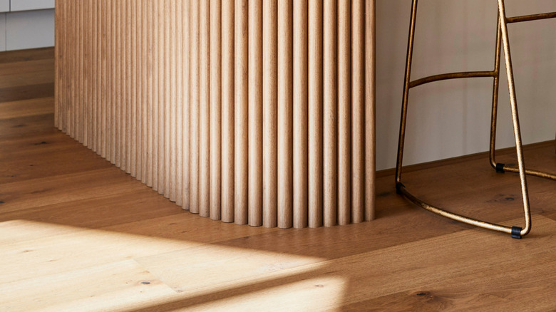 A kitchen island with fluted wood.