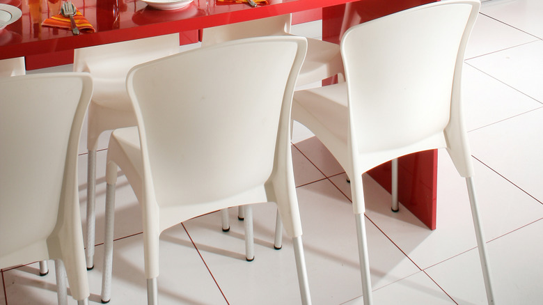 A white kitchen with bright red accents.