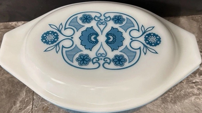 A white and blue Pyrex Horizon Blue casserole dish lid