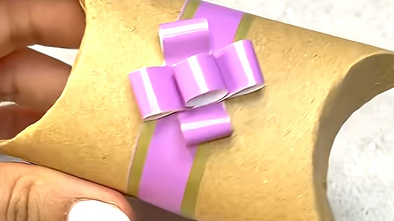 Toilet paper roll gift box with purple bow