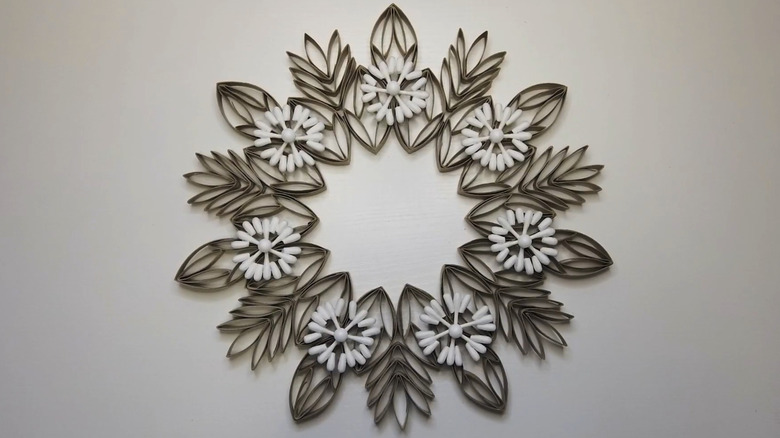 Toilet paper roll winter themed wreath on a white wall