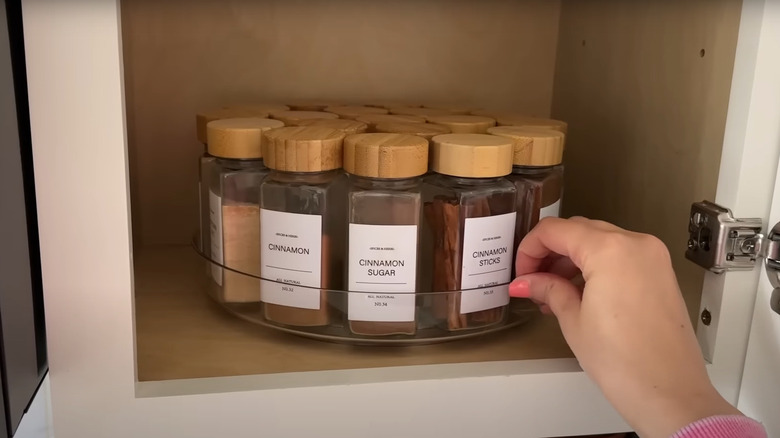 Plastic dollar store Lazy Susan turntable with assorted spices in organized jars