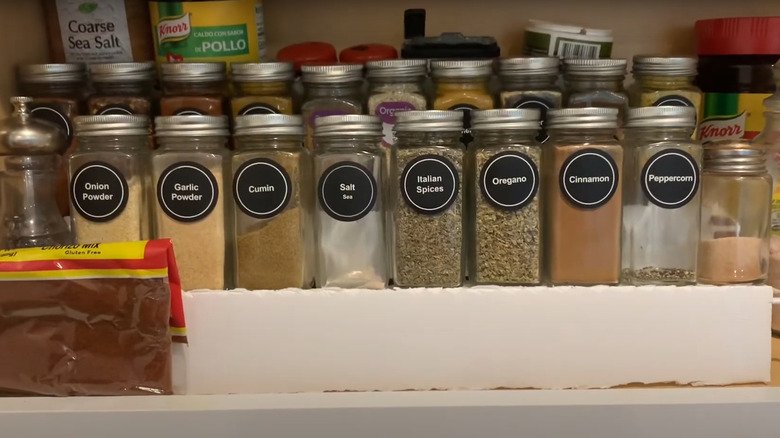 Matching spice containers on Dollar Tree rack with white cover