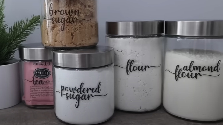 Common kitchen ingredients organized into glass jars with stainless steel lids