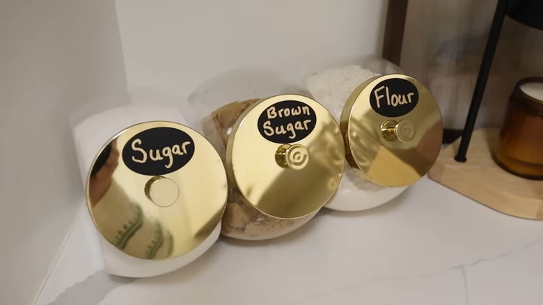 Dollar Tree candy jars filled with labeled kitchen ingredients