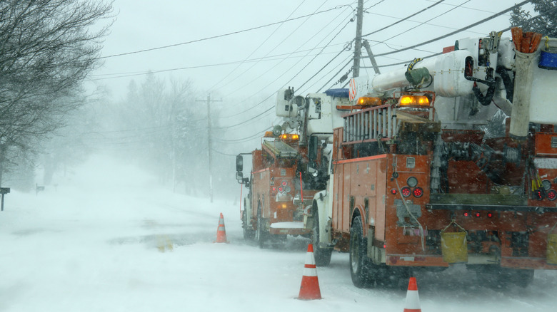 Power crew repairing downed power lines in a winter storm