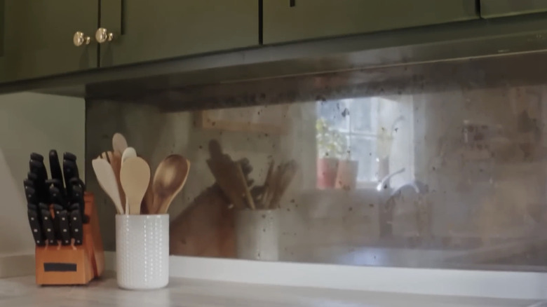A close-up of an antique mirror backsplash.