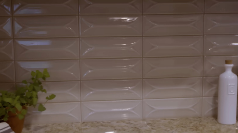 A close-up of a three-dimensional subway tile backsplash.