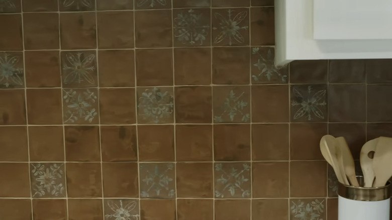 A close-up of rustic hand-painted clay tiles.