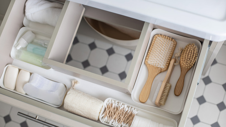 Bathroom drawer organized with tubs