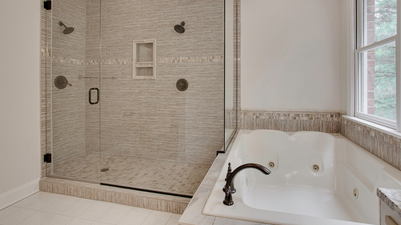 Neutral bathroom with tan tile and a large, white jacuzzi tub