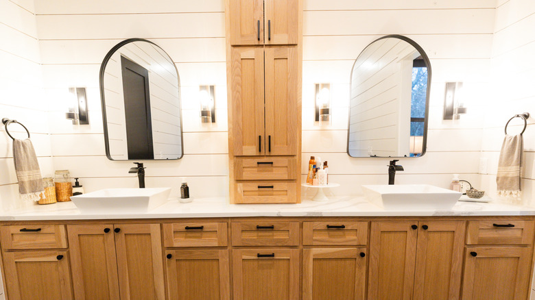 A farmhouse bathroom with Shaker-style wood cabinetry.