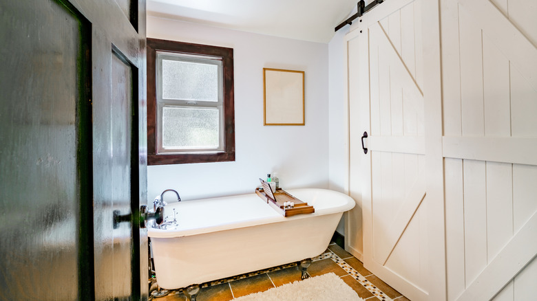 A door opening into a farmhouse-style bathroom.