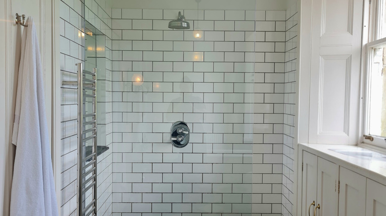 A large walk-in shower with subway tile.