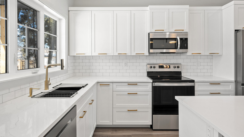 White kitchen with wood cabinets