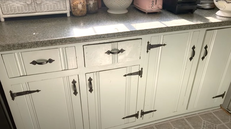 Kitchen cabinets with old-fashioned decorative hinges