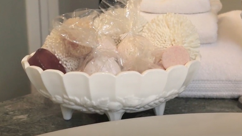 Assortment of bath bombs inside a milk glass bowl