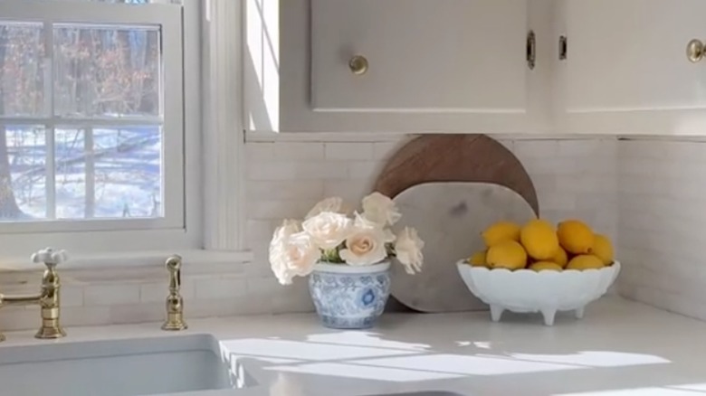 Lemons in a milk glass bowl in a kitchen